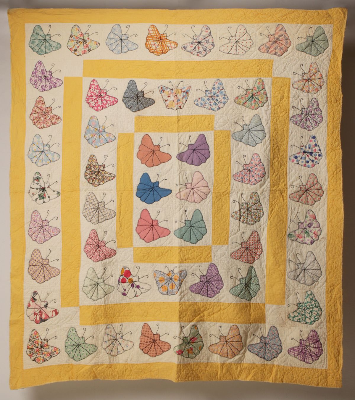 A 1930s BUTTERFLY EMBROIDERED APPLIQUE QUILT