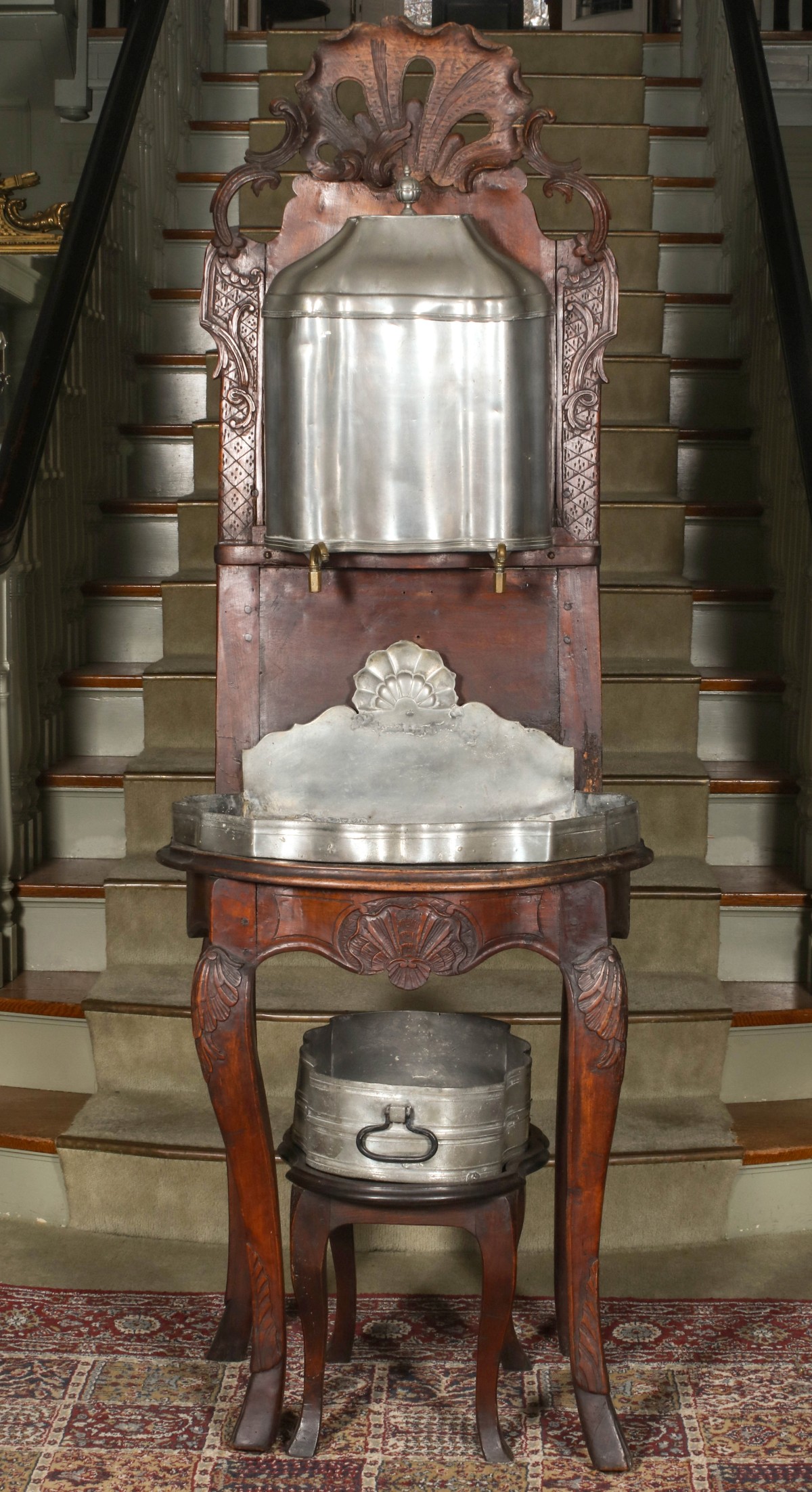 A LOUIS XV PERIOD HEAVILY CARVED FRENCH WALNUT LAVABO