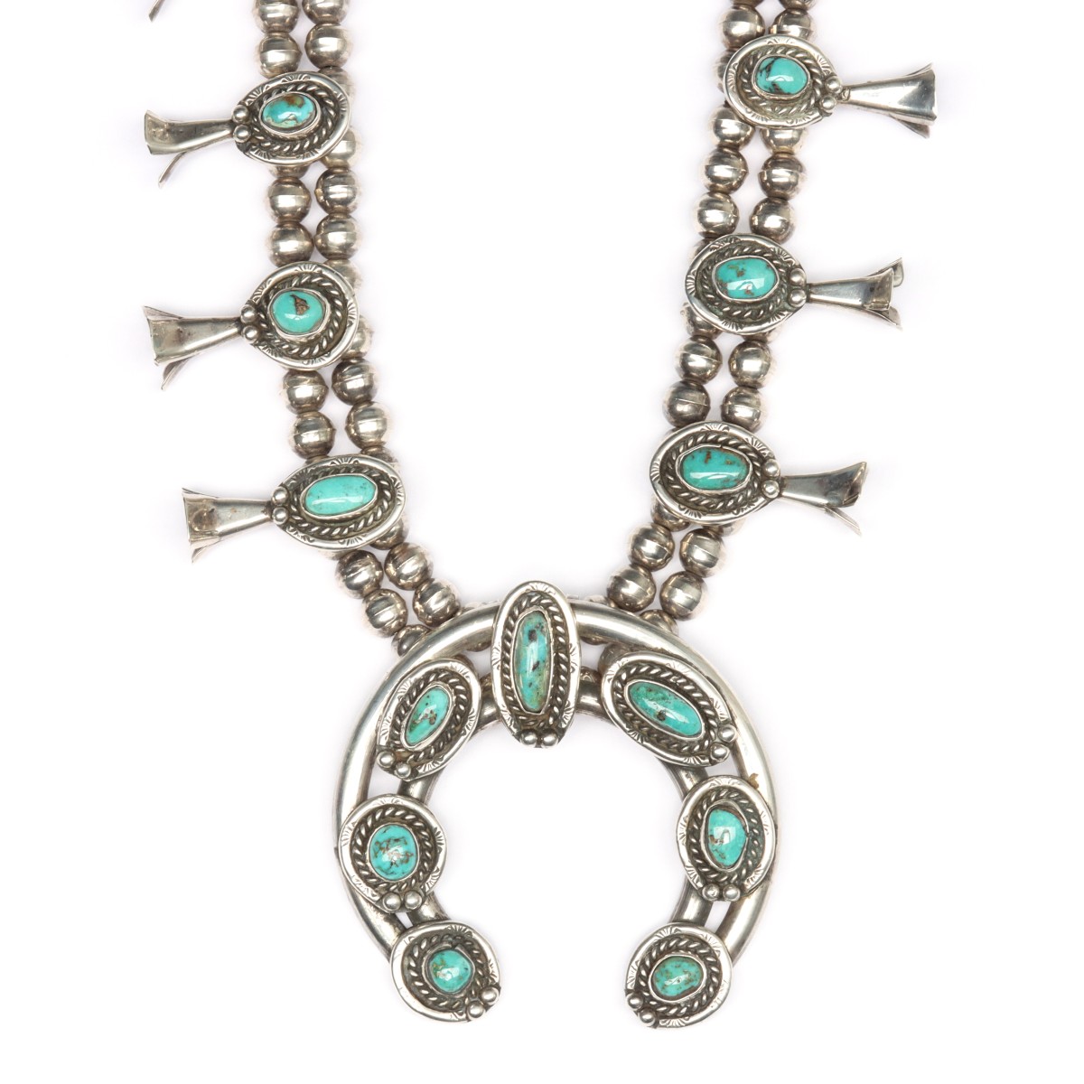 A STERLING AND TURQUOISE SQUASH BLOSSOM NECKLACE