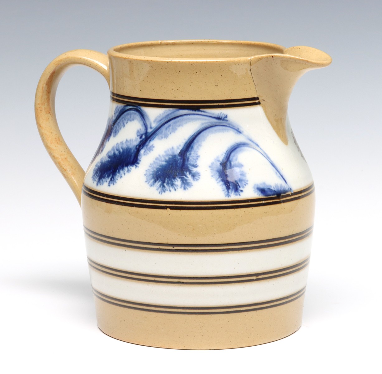 A YELLOW WARE PITCHER WITH SEAWEED DECORATION