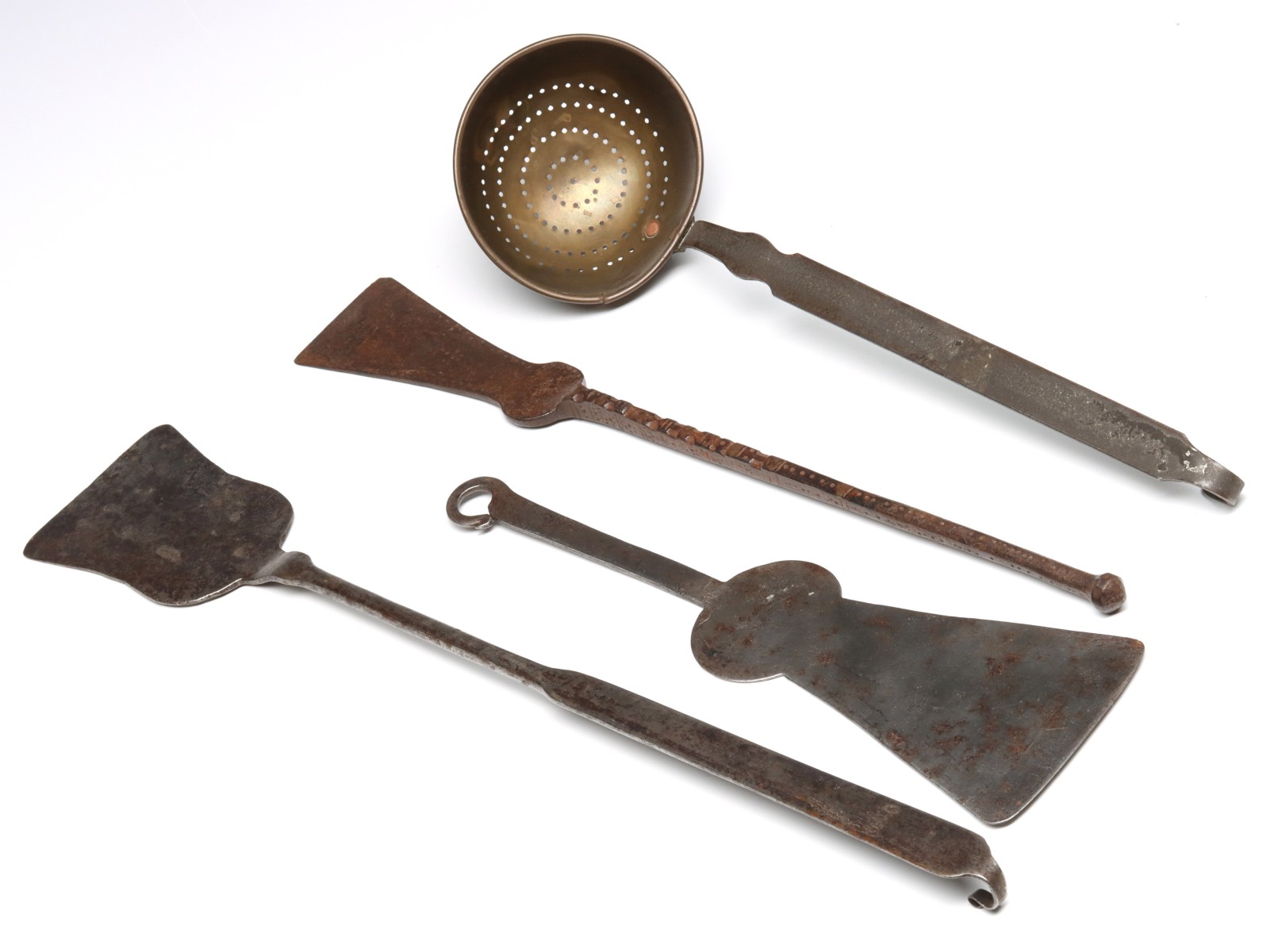 A COLLECTION OF FORGED IRON HEARTH UTENSILS