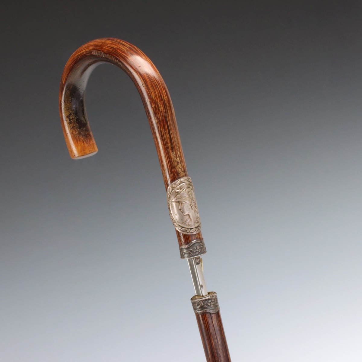 A 19TH C. PARTRIDGE WOOD CANE WITH TOLEDO BLADE