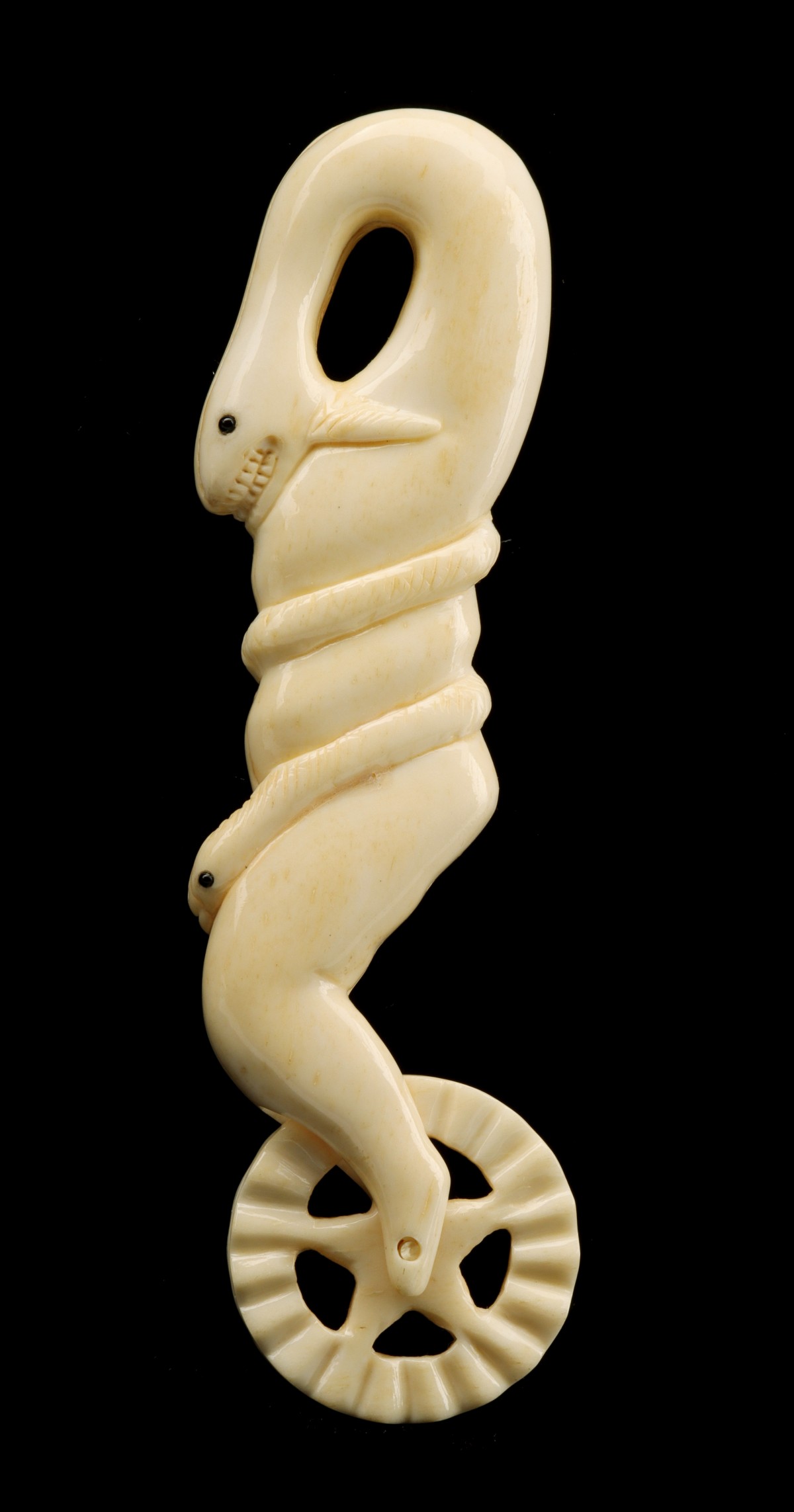 A PIE CRIMPER WITH FIGURAL WHALE AND SNAKE