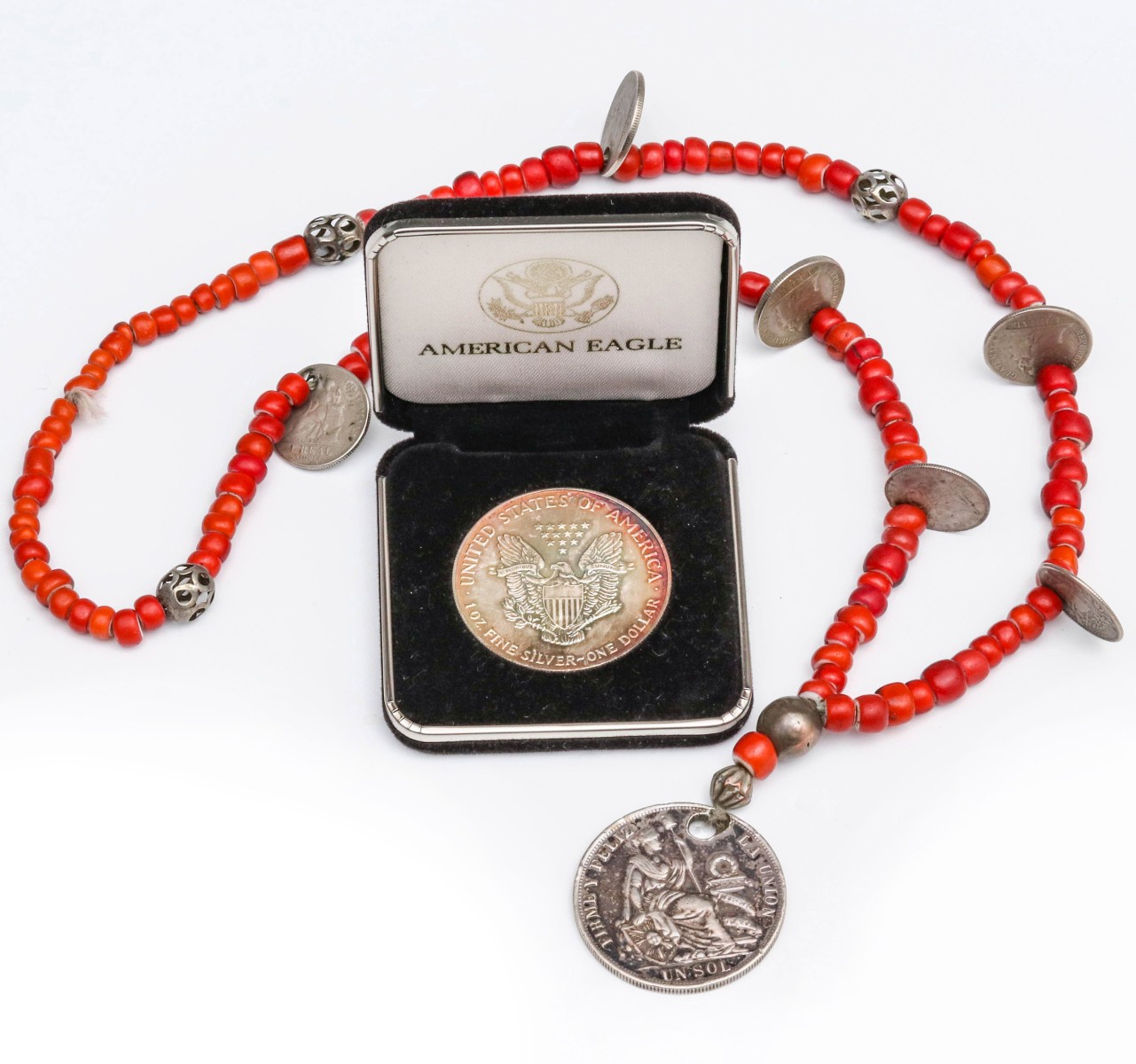 A NECKLACE WITH 19C PERUVIAN COINS, AND A SILVER ROUND