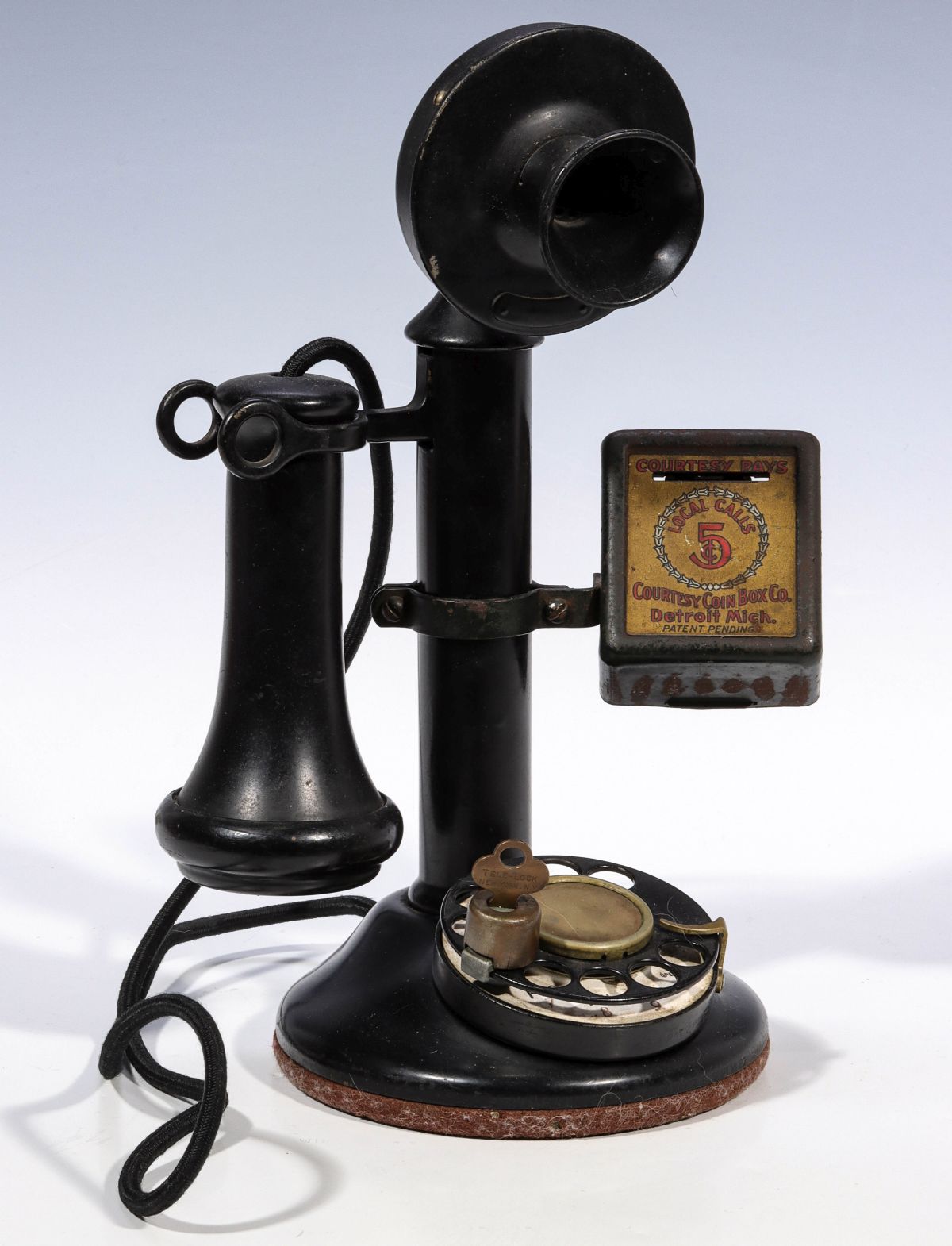 AN EARLY 20TH C. CANDLESTICK PHONE WITH 5Â¢ PAY BOX
