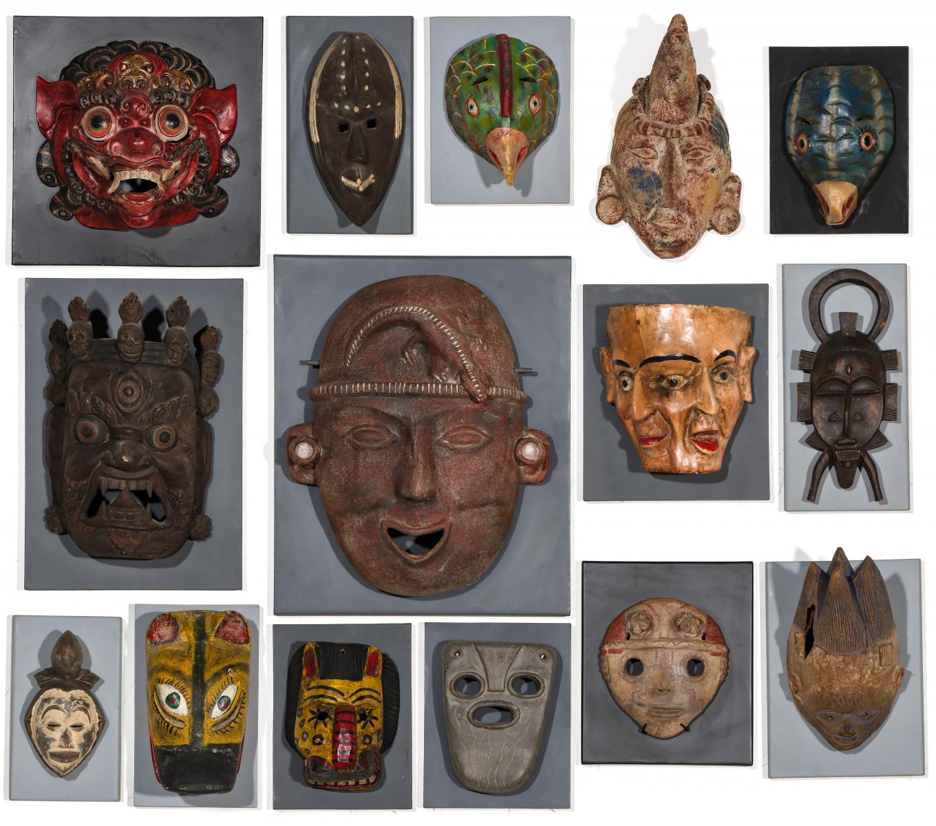 A COLLECTION OF PAINTED WOOD AND TERRA COTTA MASKS