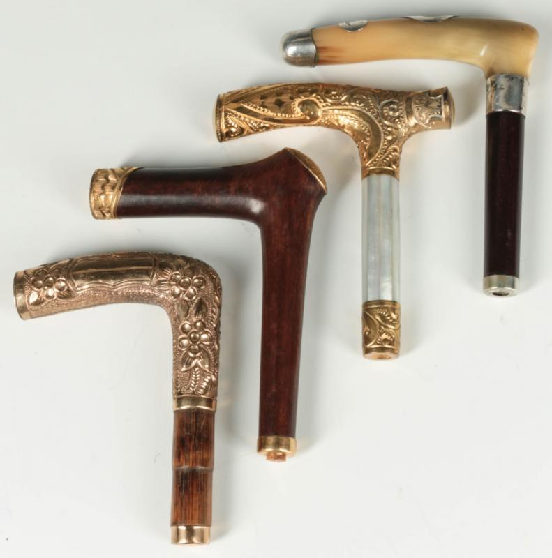 FOUR ANTIQUE CANE HANDLES WITH GOLD FILLED MOUNTS